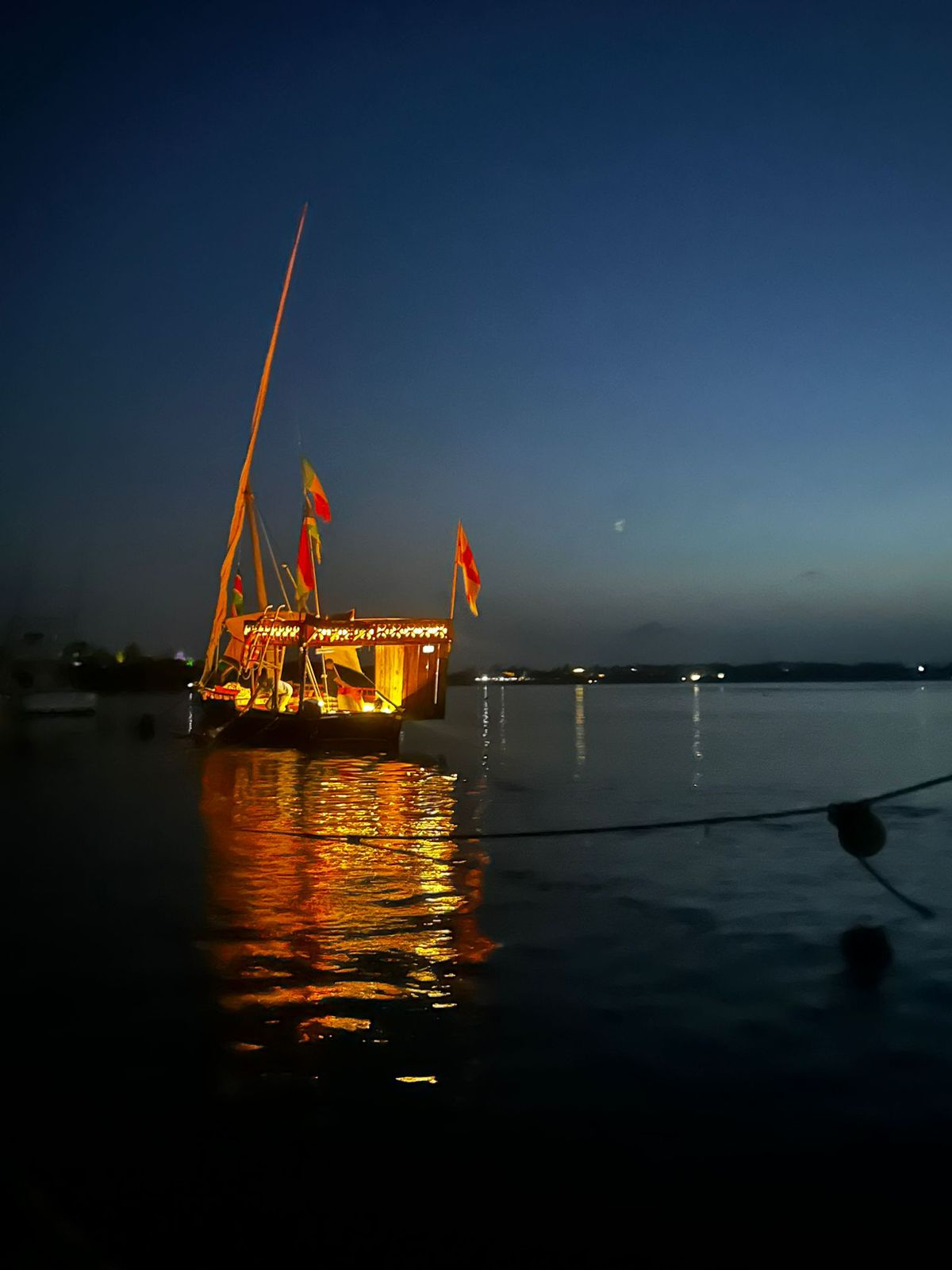The dhow lit up at dusk